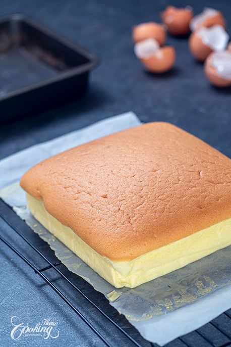 a close up of a bread on a piece of paper with eggs in the background