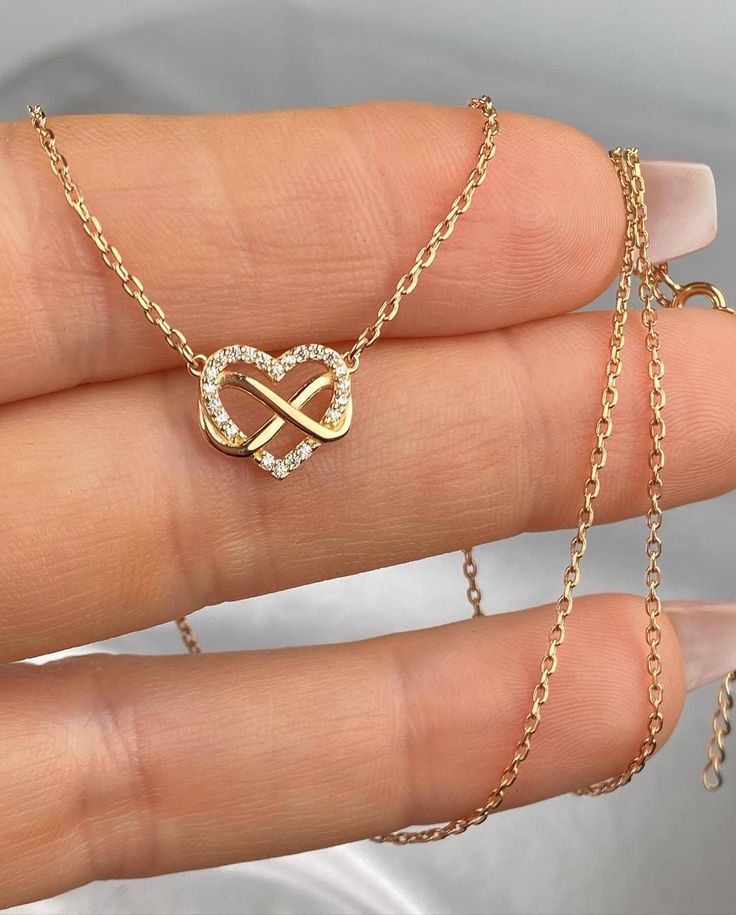 ✨ Silver Necklace with Heart-Shaped Pendant and Infinity Symbol ✨ This delicate and elegant necklace is a symbol of your deepest feelings ❤️. The pendant is crafted in the shape of a heart, with its outline adorned with sparkling zirconia stones, adding a special charm and refinement to the piece 💎. The heart intertwines with the infinity symbol, representing eternal love and an unbreakable bond between you and your loved one ♾️. The necklace is rhodium-plated, providing extra shine and protect Infinity Heart Necklace, Silver Infinity Dainty Necklace, Silver Dainty Infinity Necklace, Dainty Silver Infinity Necklace, Silver Infinity Necklace In Dainty Style, Dainty Infinity Necklace For Anniversary, Dainty Infinity Rose Gold Necklace, Everyday Delicate Infinity Chain Necklace, Dainty Rose Gold Infinity Necklace