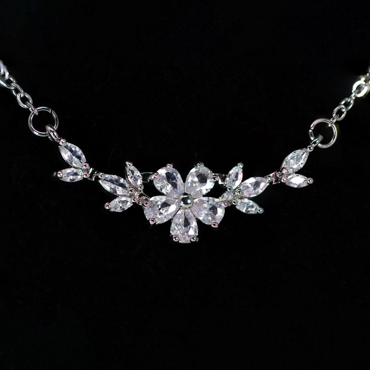 New to our Millennium collection, These beautiful romantic Swarovski Crystal Dainty Gilded Flora Serenade necklace are made of very fine quality of Swarovski crystals/ Cz diamonds and plated with platinum for your special day! Even we have hard time taking pictures because of their shine 😄 so we want to shine our brides on their special days. Simulated diamonds are also known as diamond simulants and include things like cubic zirconia (CZ), moissanite, and YAG. They can also include some natura Elegant Rhinestone Necklace With Adjustable Chain For Wedding, Elegant Flower Necklace With Clavicle Chain For Party, Elegant Crystal Bridal Necklace With Adjustable Chain, Wedding Rhinestone Pendant Necklace With Clavicle Chain, Wedding Rhinestone Clavicle Chain Necklace, Crystal Flower-shaped Necklaces For Parties, Elegant Flower Necklace With Adjustable Chain, Elegant Flower Pendant Necklace With Adjustable Chain, Wedding Necklace With Adjustable Chain And Flower Pendant