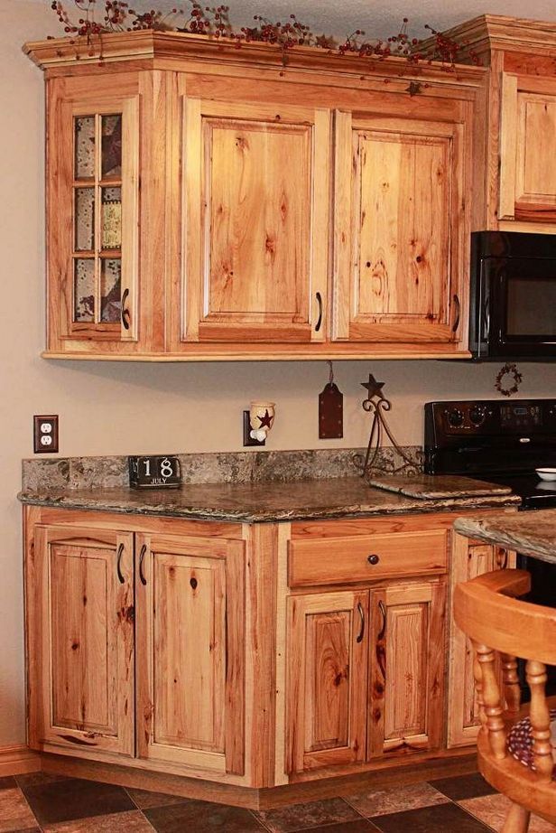 a kitchen with wooden cabinets and granite counter tops