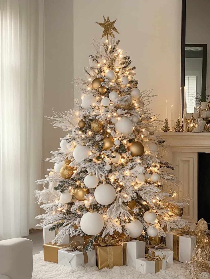 a white christmas tree with gold and silver ornaments