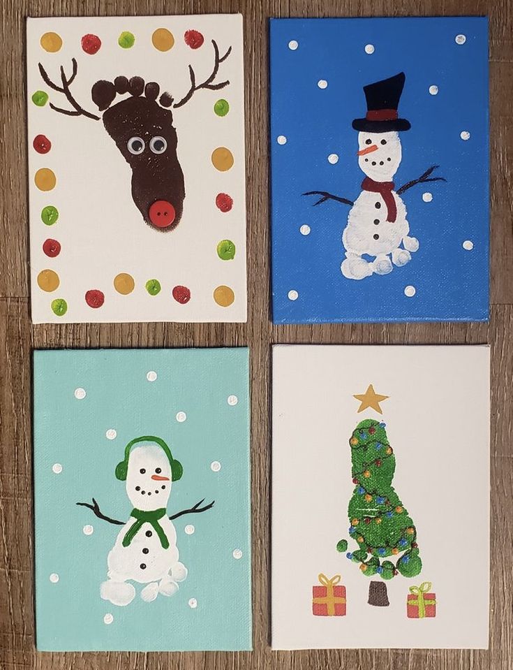 four christmas cards on a wooden table with snowman, reindeer and tree in the middle