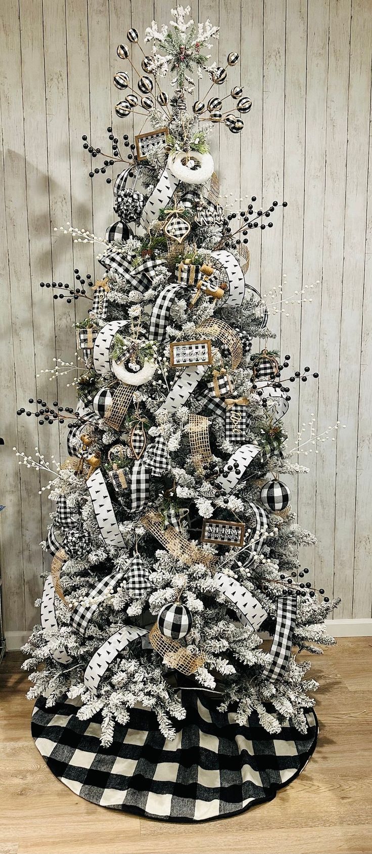 a christmas tree decorated with black and white ornaments