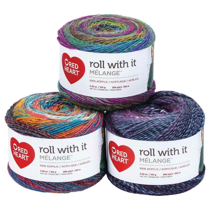 three skeins of red heart roll with it melange yarn in various colors