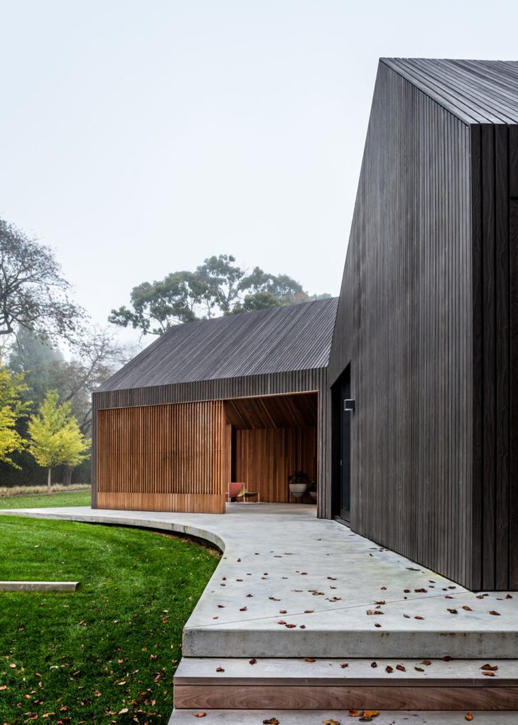 the house is made out of wood and has stairs leading up to it's entrance