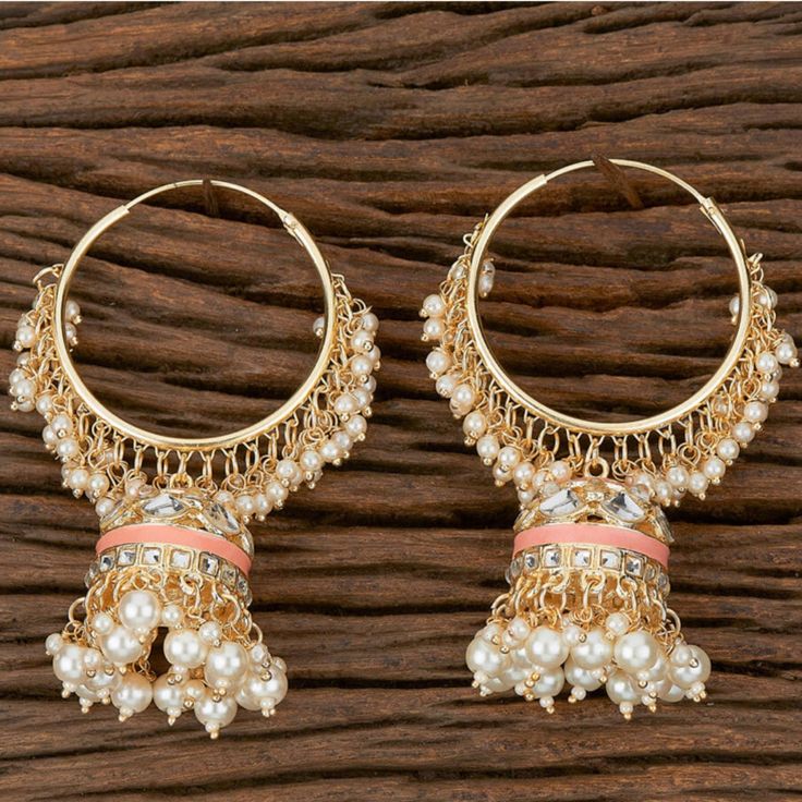 Peach Jhumka with pearl. Handcrafted pair of earrings. Gives a traditional look. Can be worn for engagement and wedding parties. Indulge in it or gift it and watch the compliments flow! It is advisable to store jewelry in a zip lock pouch (air tight pouch), keep away from water perfume and other chemicals and clean it with soft cloth. Festive Temple Jewelry Pearl Earrings With Latkans, Temple Jewelry Style Meenakari Hoop Earrings For Diwali, Temple Jewelry Pearl Earrings With Latkans For Festivals, Temple Style Pearl Earrings With Latkans For Festivals, Traditional Pink Pearl Earrings For Festive Occasions, Round Hoop Earrings With Meenakari For Diwali, Bollywood Festive Hoop Earrings With Meenakari, Festive Bollywood Hoop Earrings With Meenakari, Temple Jewelry Pearl Chandbali Earrings With Meenakari