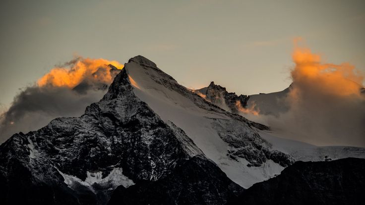 the top of a mountain covered in clouds