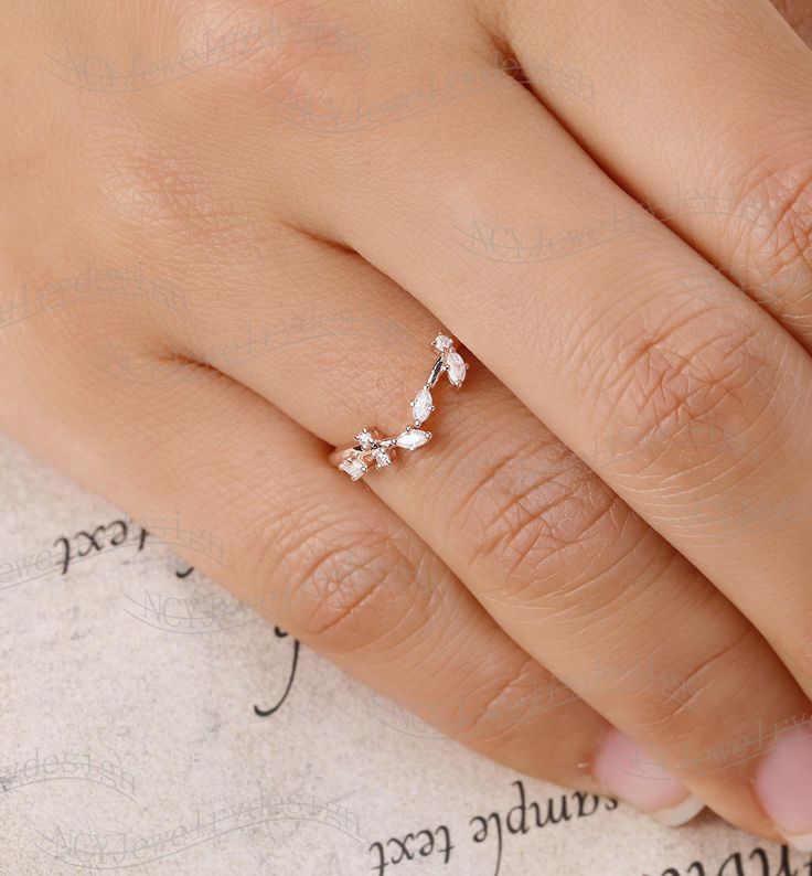 a woman's hand with a ring on it and the word love written in cursive writing