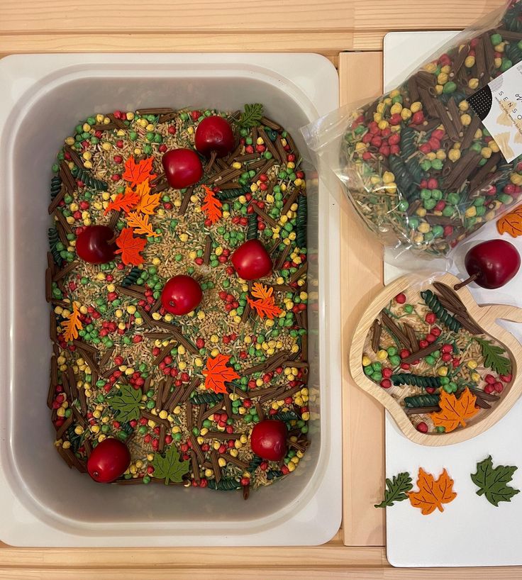 a casserole dish is decorated with fall leaves and candy