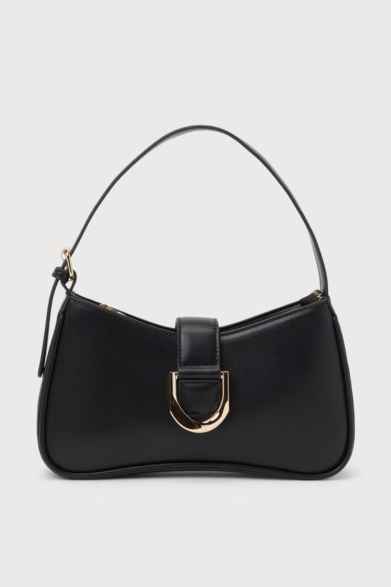 The Lulus Oh-So Chic Black Buckle Shoulder Bag was made for every girl-on-the-go! Smooth faux leather shapes this ultra-chic handbag with a structured design and an adjustable shoulder strap. A wide strap with an oversized buckle detail and a hidden magnetic closure lifts to reveal a zippered top that opens up to a lined interior with a sidewall pouch and zippered pocket. Gold hardware throughout creates an elevated look! Lined. Bag Measures 10. 5" Wide, 6" Tall, And 2" Deep. Adjustable Shoulder Chic Crossbody Baguette Bag With Adjustable Handle, Chic Baguette Crossbody Bag With Adjustable Handle, Trendy Leather Shoulder Bag With Single Handle, Office Shoulder Bag Satchel With Single Handle, Office Satchel Shoulder Bag With Single Handle, Chic Crossbody Hobo Bag With Adjustable Handle, Chic Satchel Baguette Bag With Adjustable Handle, Chic Hobo Bag With Adjustable Crossbody Handle, Chic Hobo Bag With Adjustable Handle And Crossbody Shape