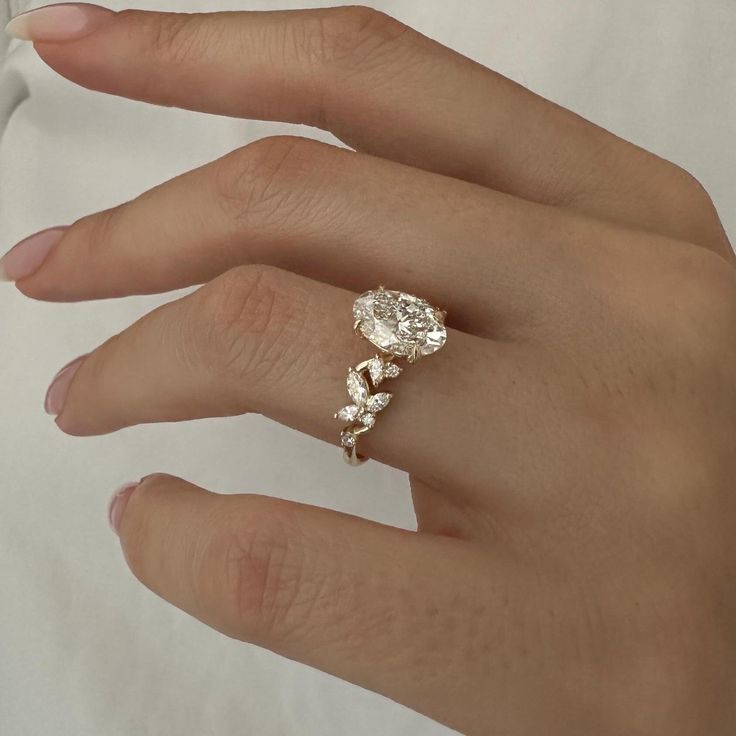 a woman's hand with a diamond ring on it