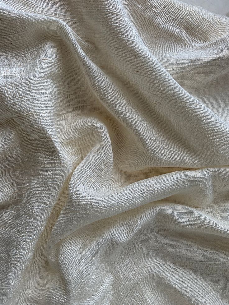 an image of a white cloth textured with natural dyes on the bed sheet