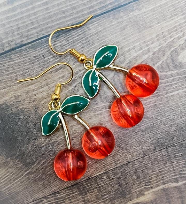 Beautiful handmade cherry glass dangle earring charms are the perfect accessory for your summer outfit! Grab your unique jewelry treasures today before this rare item is gone! Thank you so much for supporting my shop and helping us be able to create more beautiful unique jewelry treasures!  WHAT YOU GET: Handmade cherry glass charm dangle earrings will come packaged with care in a gifted jewelry box, where you can either keep your jewelry inside to store when you're not wearing it, or the gift b Trendy Handmade Cherry-colored Jewelry, Vintage Drop Earrings For Summer, Cute Cherry-colored Jewelry For Gifts, Cute Cherry-colored Jewelry Gift, Nickel-free Retro Dangle Earrings, Cherry Nickel-free Trendy Jewelry, Retro Handmade Dangle Jewelry, Handmade Retro Dangle Jewelry, Cherry Color Trendy Nickel-free Jewelry