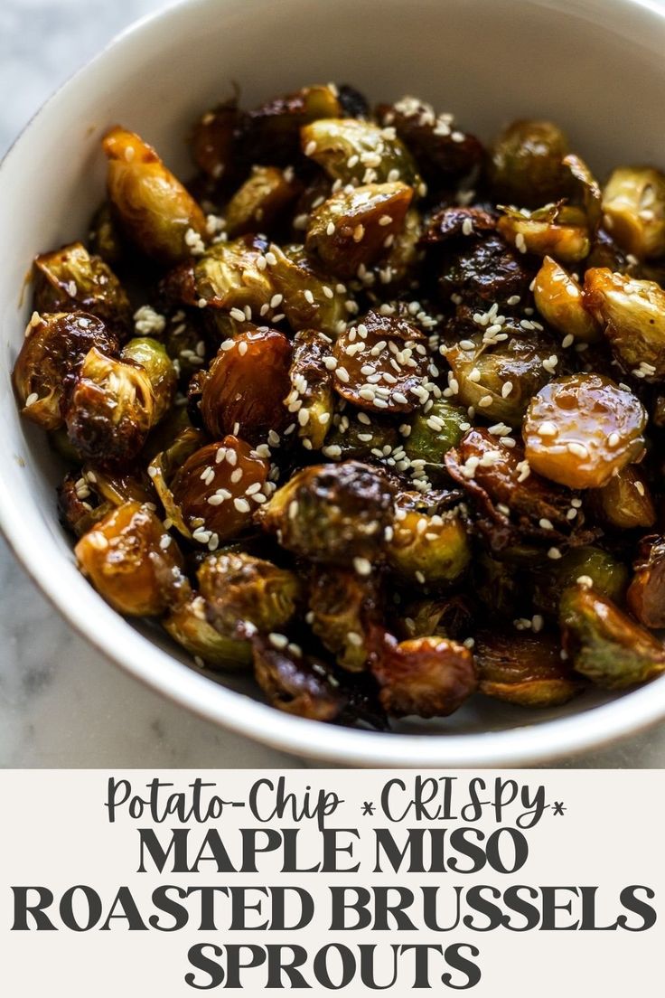 a bowl filled with roasted brussel sprouts and topped with sesame seeds