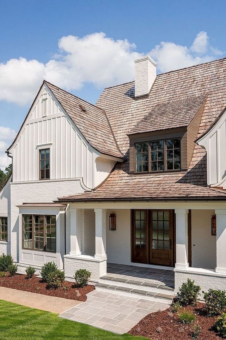 a white house with brown shingles and windows