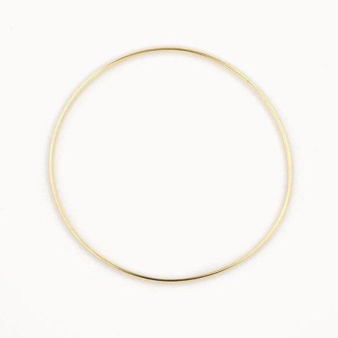 14k gold plated Sterling Silver 63cm inner diameter  1.8mm width  Our gold bangles are a classic and dainty piece of jewellery that is a staple to everyone's jewellery collection. Whether you wear it as a stand alone statement piece or later it with 2 or 3 bangles and even add some bracelets. These bangles make the perfect gift for yourself or someone special and comes packaged in a beautiful box. 14k Gold Filled Bangle In Gold Color, 14k Yellow Gold Bracelet With Simple Design, Simple 14k Yellow Gold Bracelet, Yellow Gold 14k Bracelet, Gold Hoop Bangle In Minimalist Style, Minimalist Gold Hoop Bangle, Minimalist Gold Hoop Bracelet, Simple Bangle Jewelry For Everyday Use, Minimalist Brass Gold Bracelet Tarnish Resistant