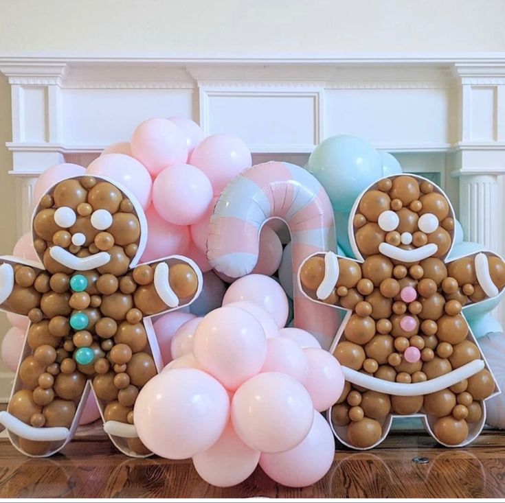 gingerbread man and woman made out of balloons on the floor next to other decorations