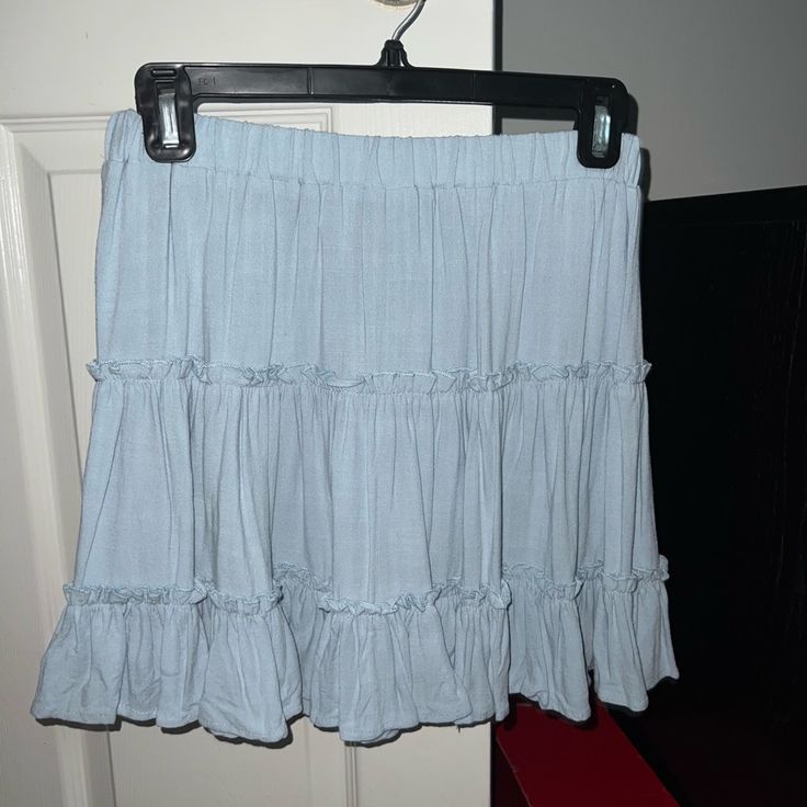 a blue skirt hanging on a door hanger