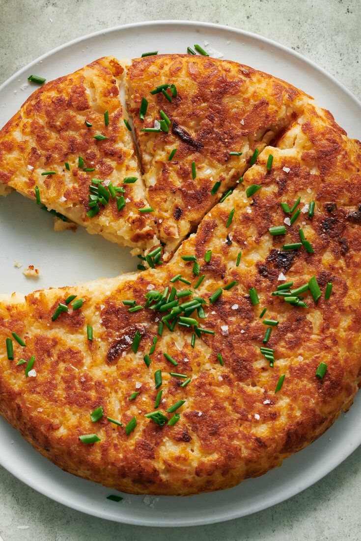 a cheese pizza is cut into slices on a white plate