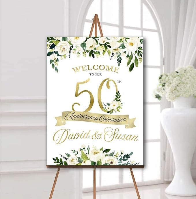 a welcome sign with flowers and greenery is displayed in front of a white vase