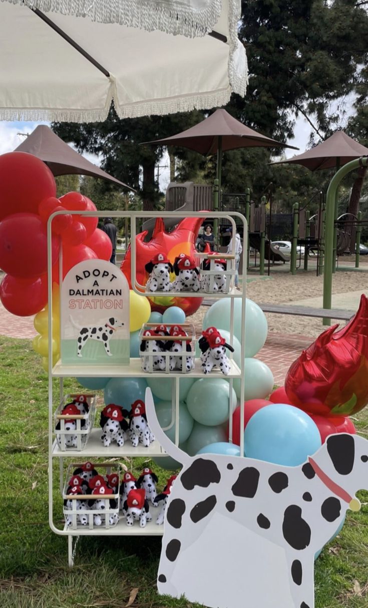 a display with balloons and dalmatian figurines