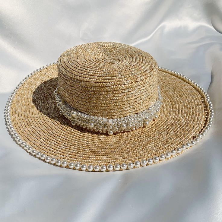 Handwoven straw hat with pearl trim detailing Band at centre of hat is removable Circumference 56-59cm (can be adjusted slightly with inner drawstring) Brim 10cm Made in UK Woman owned small business  Handmade Elegant Braided Straw Hat For Summer, Elegant Braided Hats For Spring, Elegant Braided Hat For Spring, Elegant Braided Brimmed Sun Hat, Elegant Adjustable Braided Hat, Elegant Braided Straw Hat With Flat Brim, Elegant Braided Toquilla Straw Hat, Elegant Woven Brimmed Straw Hat, Elegant Brimmed Straw Hat Made Of Paper Straw