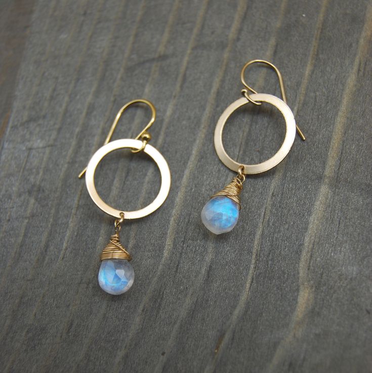 These delicate Moonstone teardrop earrings are hand wrapped in 14k gold filled wire, and dangle from an 18k gold filled flat hoop. The moonstone's iridescent nature is complimented by the delicate fine wiring. The magical milky blue luster glows from within the gemstone, and reflects beautifully in different lights.   Moonstone is known to channel hope, sensitivity and abundance by wearing it. It's properties are also known to enhance calmness and strength, while promoting inspiration and succes Washer Jewelry, Silversmithing Jewelry, Diy Wire Earrings, Wrapping Jewelry, Beaded Earrings Diy, Diy Earring, Wrap Earrings, Earrings Wire, Mixed Metal Jewelry