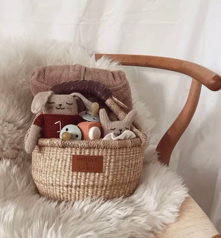 a basket filled with toys sitting on top of a wooden chair next to a white rug