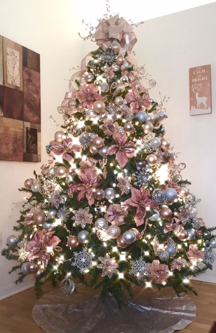 a decorated christmas tree with pink and silver ornaments