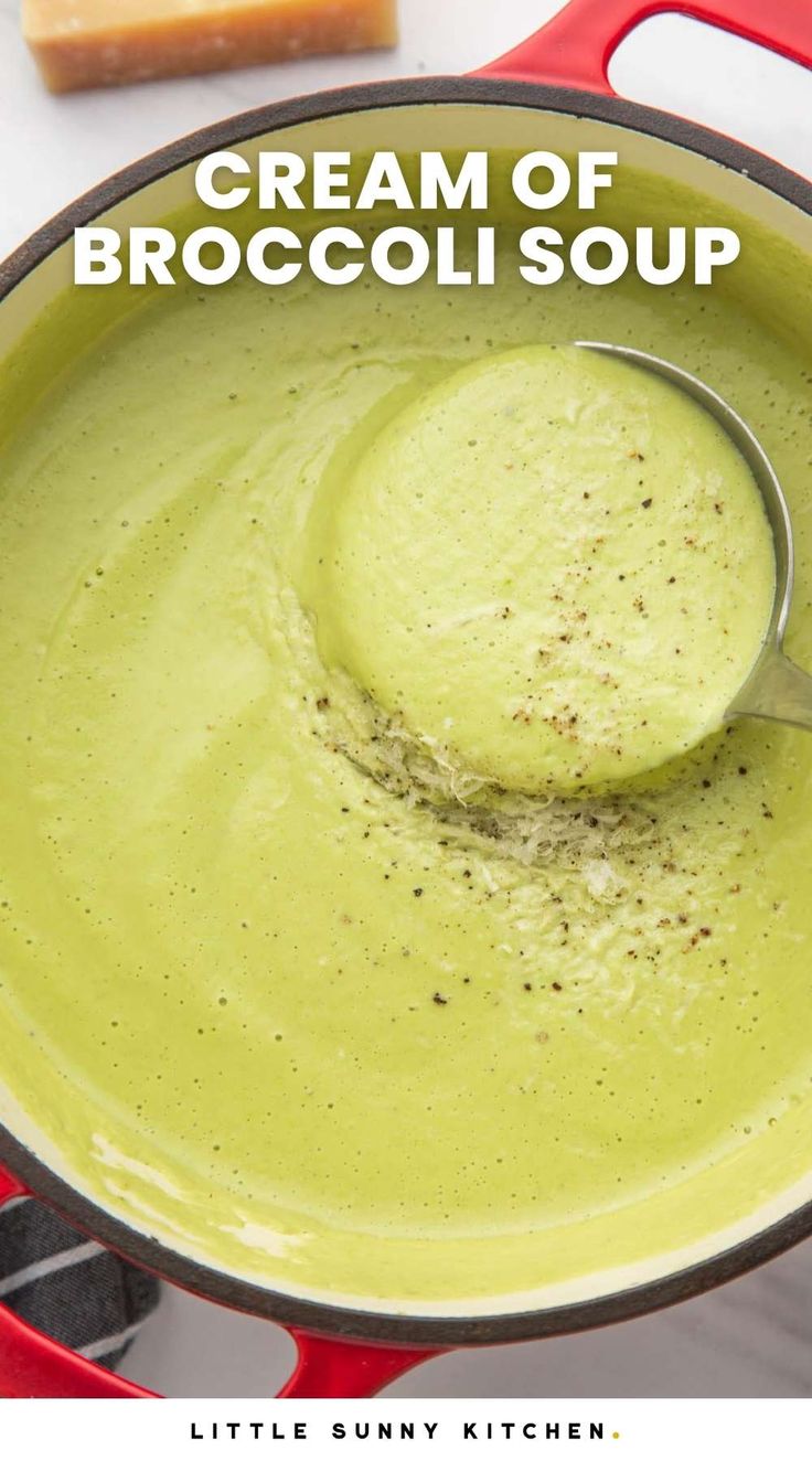 creamy broccoli soup in a red pot with a ladle scooping out