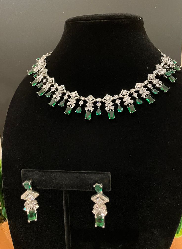 Beautiful and elegant Choker with high quality stones. Comes with a pair of matching earrings in silver and emerald finish. Can pair well with any outfit or dress for a night out! The green stone is amazing quality and is such a beautiful tone. Elegant Party Jewelry Sets With Stone Setting, Elegant Crystal Jewelry Sets With Stone Setting, Elegant Emerald Necklace With Jewels For Party, Dazzling Emerald Necklace For Formal Occasions, Elegant Emerald Necklace For Formal Occasion, Elegant Emerald Necklace For Party, Elegant Green Stone Jewelry, Elegant Emerald Necklace With Stones For Formal Events, Elegant Crystal Emerald Necklace With Jewels