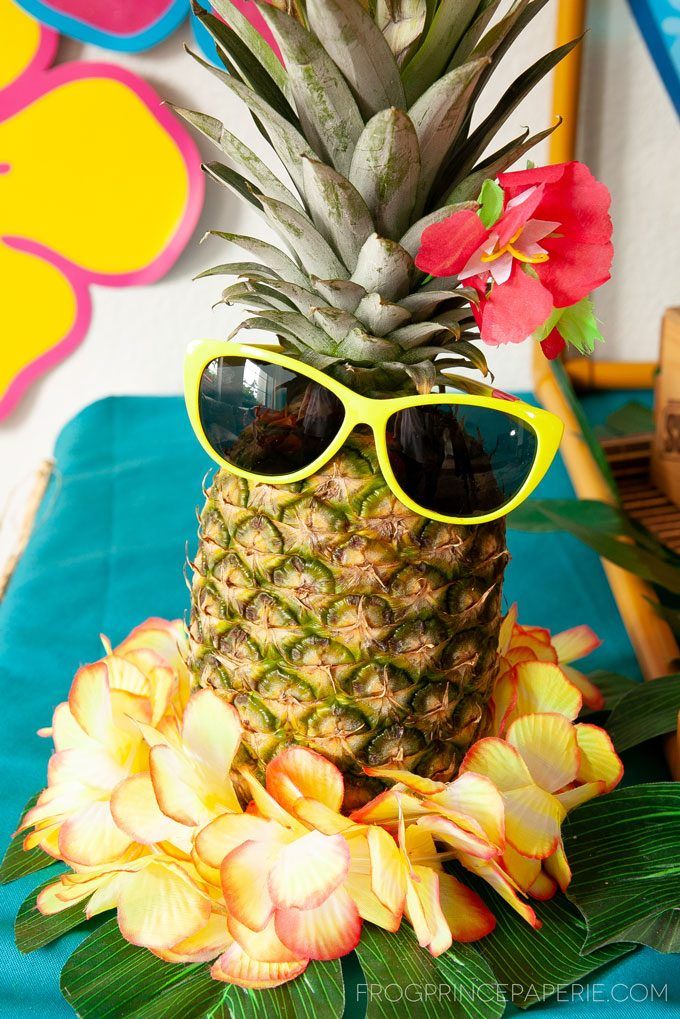 a pineapple wearing sunglasses on top of flowers