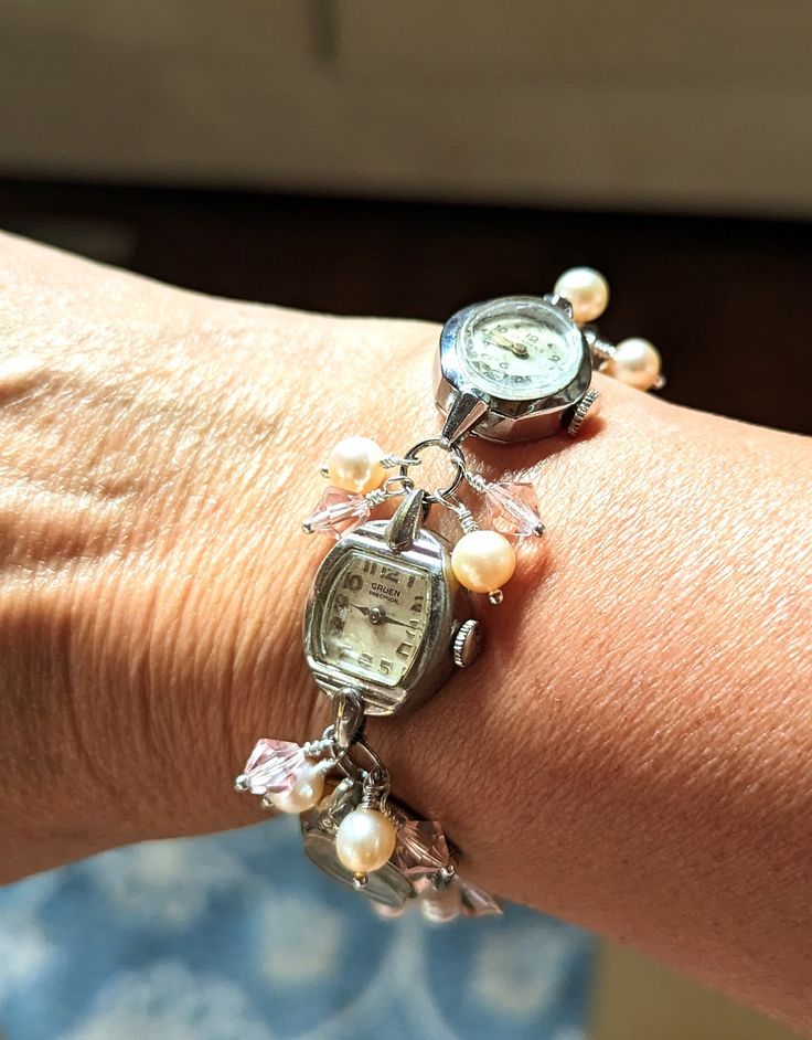 FUN! This is a bracelet made from vintage watches dating from the 1930s and up. There are a variety of watches used; this one includes Helbros 10k RGP, Cramers 17 jewel, Gruen Precision 17 jewel 10k RGP and Vail 10k RGP. I just love the different shapes of the watches! I've used pink faux pearls and pink crystals in this bracelet.  The bracelet measures about 1/2" wide and 7.25" long but can be shortened or lengthened to your specifications, simply send me a message. Each of my pieces are one of Adjustable Silver Jewelry For Vintage Events, Vintage Adjustable Silver Watch Bands, Vintage Silver Adjustable Watch Bands, Vintage Jubilee Bracelets For Wedding, Classic Metal Watch Bands For Gifts, Vintage Adjustable Bracelets For Wedding, Vintage Stainless Steel Watches With Bracelet Strap, Adjustable Vintage Bracelet For Wedding, Vintage Charm Bracelets For Wedding