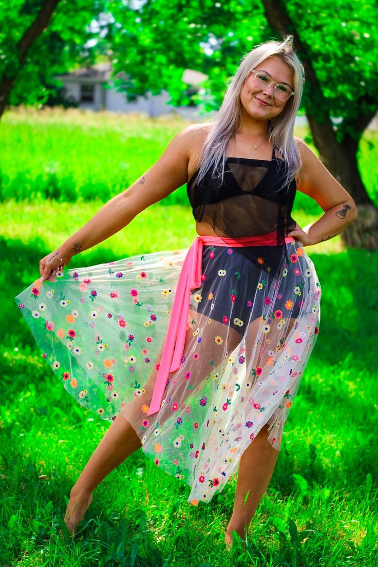 Step into the spotlight with our stunning neon flower tulle wrap skirt, designed to make a statement! This eye-catching piece features a vibrant, neon floral pattern that glows beautifully under blacklight. The wrap design allows for a customizable fit, making it versatile & comfortable to wear. Perfect for dance parties, festivals, or any occasion where fun meets fashion. Summer Beach Skirt With Floral Embroidery, Spring Multicolor Floral Embroidery Skirt, Multicolor Tulle Skirt For Spring, Summer Festival Skirt With Floral Embroidery, Sheer Beach Skirt For Spring, Spring Festival Skirt With Floral Embroidery, Spring Festival Denim Skirt, Neon Flowers, Festival Skirts