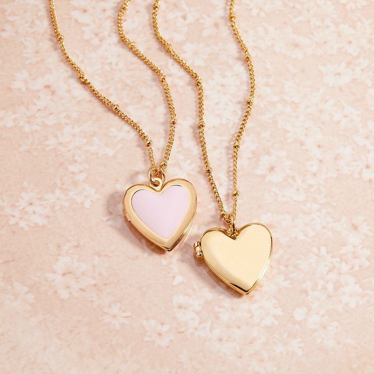 Fall in love with this golden locket that's shaped like a heart. Get lost in the timeless style of the Isla Heart Locket, sure to be your newest accessory crush. Perfect for wearing your heart outside your chest. Available in 14k gold plated brass Pendant size: 5/8" by 3/4" 16" satellite chain with 2" extender Lobster claw closure Water resistant and protective anti-tarnish barrier SKU: BYN1435 Dainty Heart Necklace With Locket, Gold Plated Heart Necklace With Charms, Heart Locket Necklace Gift For Her, Dainty Heart Shaped Locket Necklace With Charm, Dainty Double Heart Locket Necklace With Charm, Dainty Gold-tone Heart Jewelry, Heart Shaped Tarnish Resistant Bracelet For Gift, Heart Pendant Locket Necklace As Gift For Her, Gold Plated Heart Charm Locket Necklace Gift