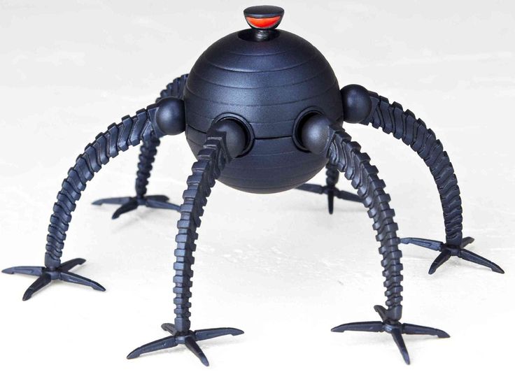 a black plastic toy with two legs and eyes