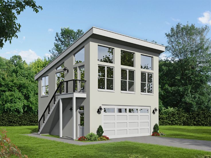 a three story house with two garages on the second floor