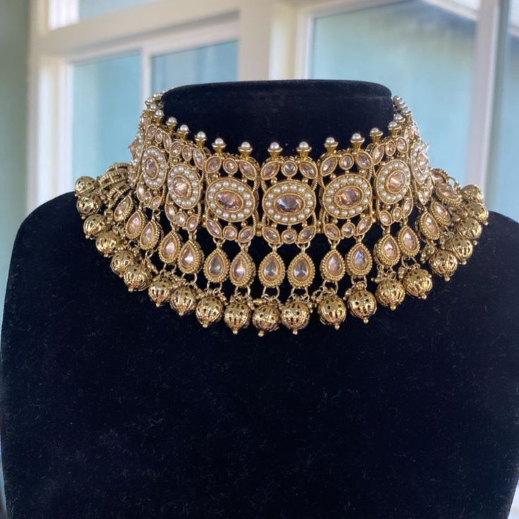 Introducing this gorgeous choker set made from fine quality polki stones. Handcrafted with fine quality Gold pearls, this set is a perfect neutral set. Comes with a pair of earrings and tikka ( headpiece). ALL SALES ARE FINAL. KINDLY MESSAGE ME FOR ANY INQUIRIES. Elegant Kundan Choker Necklace, Tilla Choker Jewelry For Reception, Tilla Choker For Reception, Tilla Choker For Reception Occasion, Elegant Kundan Jeweled Choker, Elegant Stone Work Choker For Diwali, Festive Jeweled Bridal Choker Necklace, Festive Bridal Choker Necklace With Jewels, Festive Bridal Choker With Jewels