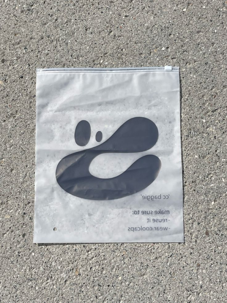 a paper bag with a black and white design on it