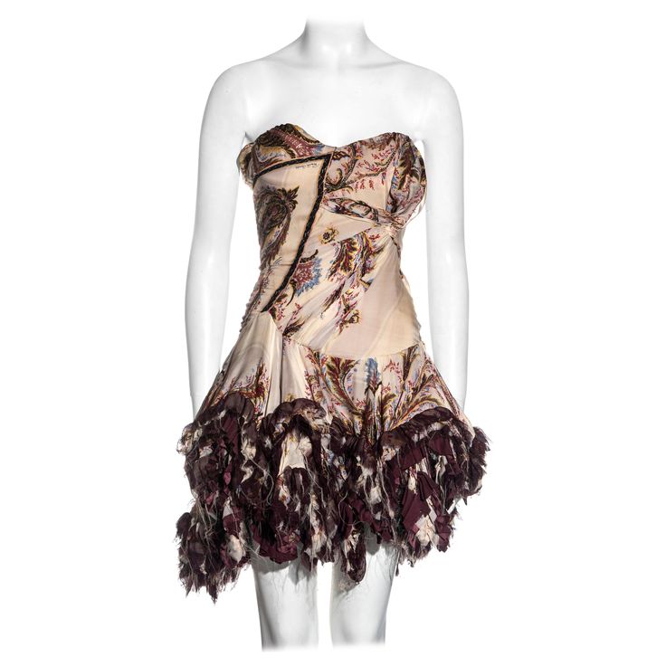 ▪ Roberto Cavalli silk corseted strapless mini dress ▪ cream, purple and metallic gold brocade printed silk ▪ Corseted bodice with asymmetric ruching and tucking ▪ Ruffled mini skirt with frayed hem ▪ Corset lace-up fastening at the back ▪ Size Small ▪ Fall-Winter 2004 ▪ 100% Silk ▪ Made in Italy Silk Strapless Corset Dress For Cocktail, Strapless Silk Corset Dress For Cocktail, Dress Fw, Dressing Outfits, Brocade Print, Silk Kimono Dress, Roberto Dress, Silk Corset, Dream Wishlist