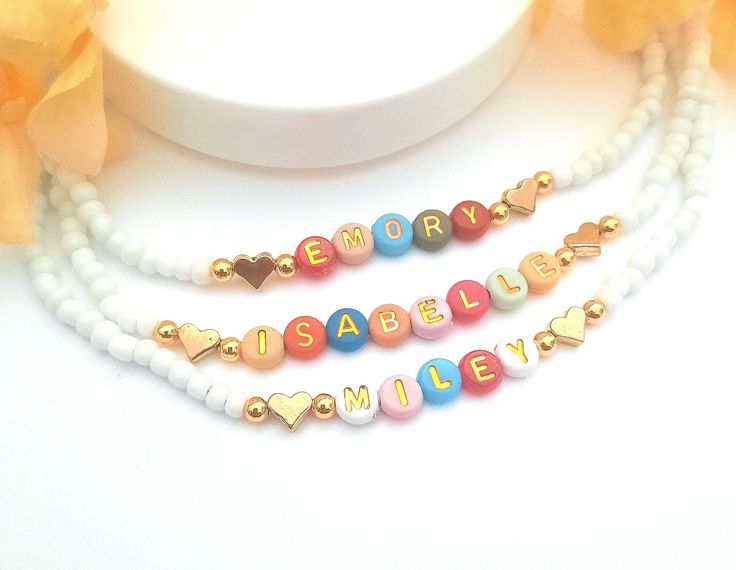 Child Name Necklace Color beads necklace gift for toddler girl jewelry for birthday Christmas gift letter bead necklace Kids name necklace This darling name necklace is so sweet, colorful and surely will make a perfect birthday gift, Christmas gift or and every day favorite accessory  100% made to order and handcrafted with excellence and precision into a beautiful, personalized name necklace that is so special and perfect for gift giving. Arrives in a white gift box with a bow ready for gifting. The colorful beads are carefully chosen to form a random color design for a personalized style. We use strong stretch cord to string the beads on. Because this necklace is a stretchy it does not require a clasp which makes this beautiful, dainty, personalized name necklace easy to put on and easy Playful Letter Beads Jewelry As Gift, Cute Beaded Necklace With Letter Beads For Birthday, Personalized Playful Adjustable Necklace, Customized White Necklace For Birthday Gift, Personalized White Necklace For Birthday Gift, Playful Letter Beads Jewelry Gift, Playful White Beaded Necklaces For Birthday, Personalized Adjustable Playful Necklaces, Playful Beaded Necklace With Letter Beads For Gift