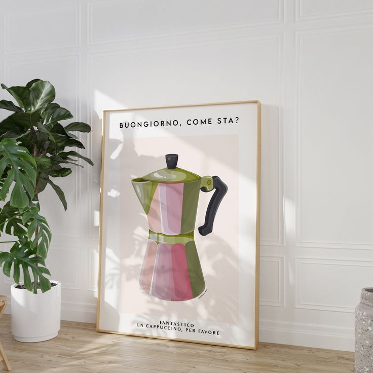 a coffee maker is on display in front of a potted plant and a framed poster