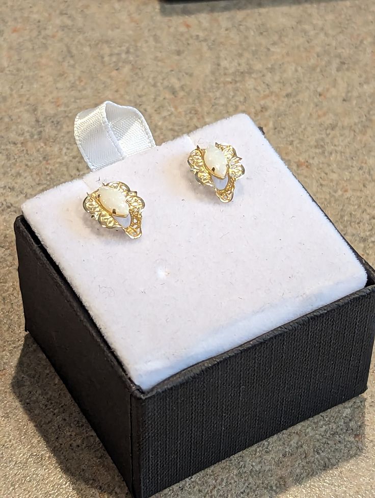 These are an absolute beautiful pair of old earrings. They are offered in excellent pre-owned antique condition.  Each earring is crafted in 14k solid yellow gold and holds a marquise cabochon natural opal. Both opals are matched nicely for size and color with flashes of pink, blue, green, yellow, orange and red!  My favorite part of this setting is the delicacy and precision detail cuts of the filigree work.  These were from a Chicago area estate and were well cared!   Small enough to be a dail Antique 14k Gold Hallmarked Earrings, White 14k Gold Filigree Jewelry, Ornate Gemstone Earrings For Formal Occasions, Victorian Hallmarked Pearl Earrings As Gift, Vintage Gold Gemstone Earrings, Gold Gemstone Clip-on Earrings For Anniversary, Victorian Oval Earrings For Anniversary, Victorian Yellow Gold Pearl Earrings For Gift, Victorian Style Yellow Gold Pearl Earrings For Gift