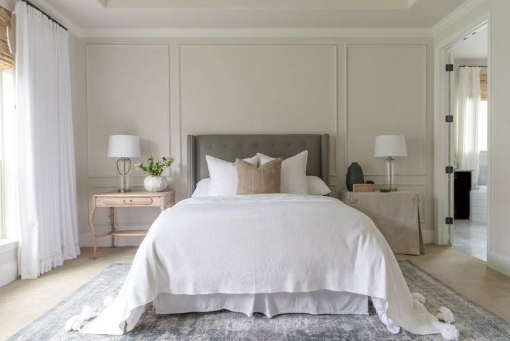 a bedroom with a large bed and white walls