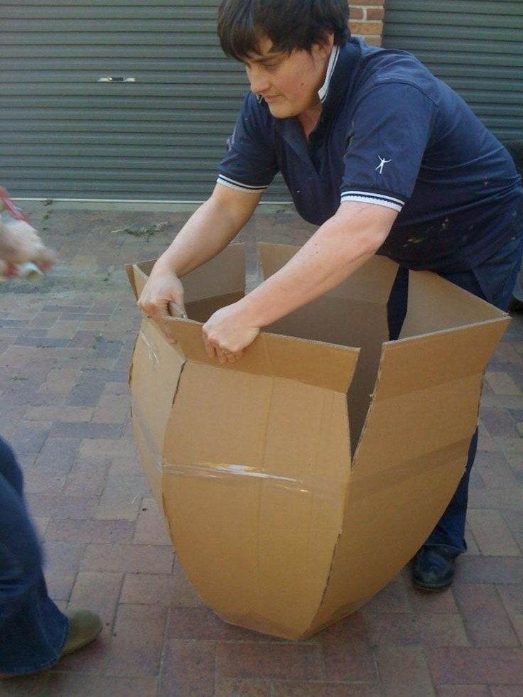 a man is opening a cardboard box on the ground