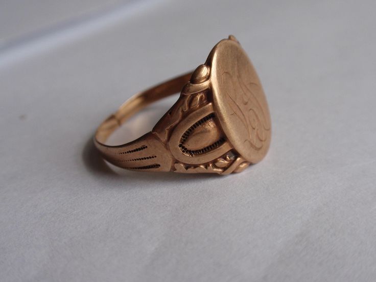 Victorian Ostby Barton Signet Ring 10k Yellow Gold.  This handsome guy weighs 3.7g, the setting measures 14.5mm tall (North to South) and he is currently a size 9. He has a nicely aged rosy gold patina that I have left as found as well as a cut band..an easy fix for your local jeweler or for future sizing.  Striking piece to add to an Ostby Barton collection. (Sadly, the maker, Ostby, perished on the Titanic in 1912).  All items are in previously loved, used condition so please review all photos Victorian Etched Ring Jewelry, Victorian Style Etched Ring Jewelry, Collectible Gold Stamped Ring, Vintage Adjustable Engraved Initial Ring, Adjustable Vintage Engraved Initial Ring, Victorian Etched Ring As A Gift, Vintage Bronze Engraved Ring As Gift, Victorian Etched Rings As A Gift, Victorian Etched Rings As Gifts