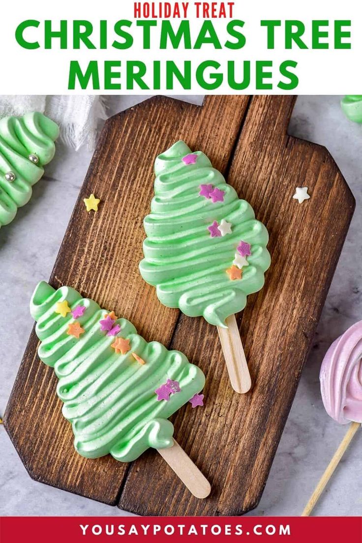 christmas tree meringue pops on a wooden cutting board with candy lollipops