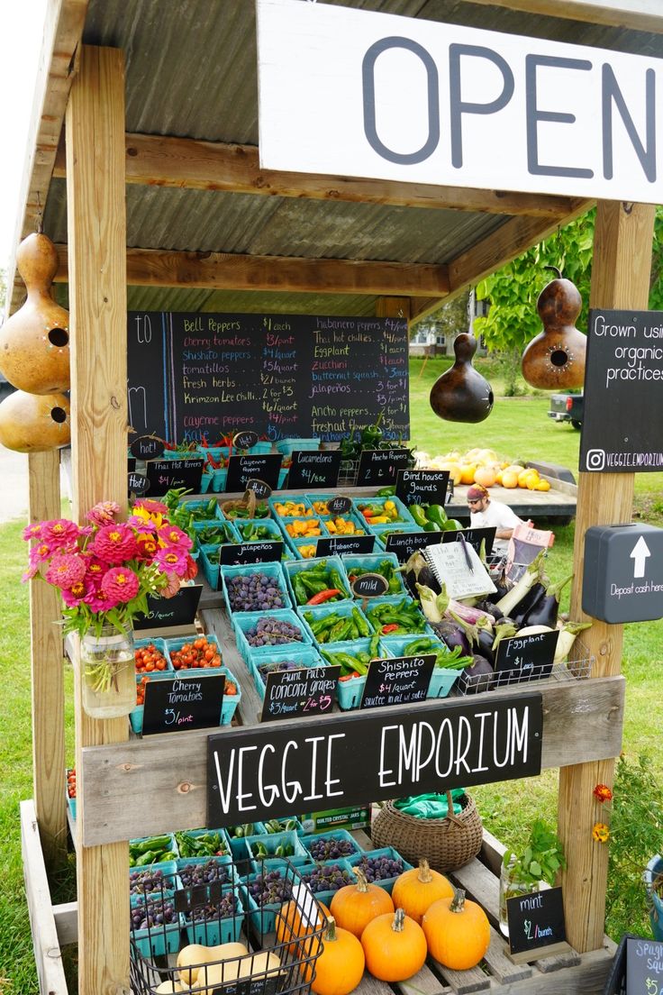 an outdoor produce stand with vegetables and fruits for sale