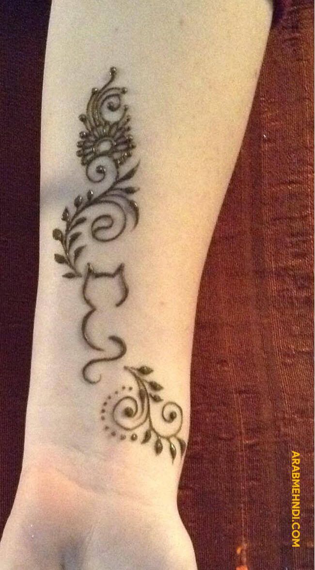 a woman's hand with a tattoo design on the arm and wrist, which is decorated