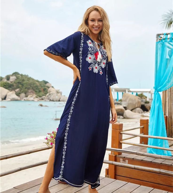 Transport back to the 70s while wearing our Boho Chic Floral Embroidered Kaftan Dress. You will feel like a flower child from 73 in the floral embroidery that decorates the bodice of this kaftan. The clashing colors of navy blue and burnt orange bring a vintage feel to this piece while its stitching and decorative embroidery adds an artistic touch that catches onlooker's attention. Wear this dress with your hair down and bare feet or sandals to connect with the spirit of the peaceful era it is i Traditional Floral Print Maxi Dress For Summer, Folk Style Floral Print Maxi Dress For Beach, Traditional Maxi Dress With Floral Print For Summer, Folk Style Embroidered Floor-length Dress, Traditional Summer Maxi Dress With Floral Print, Long Embroidered Kaftan For Beach Season, Summer Folk Style Maxi Dress With Floral Print, V-neck Floral Embroidered Dress For Eid, Bohemian Floor-length Dress With Embroidered Border